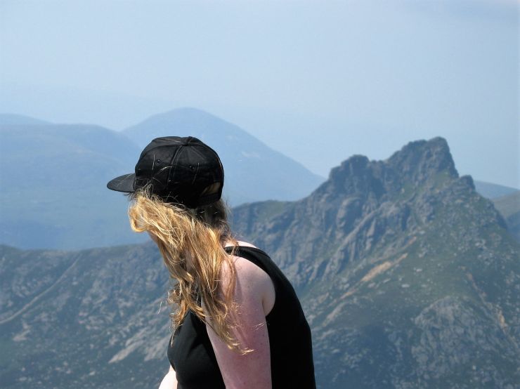 Girl with fair hair looking across a mountain view