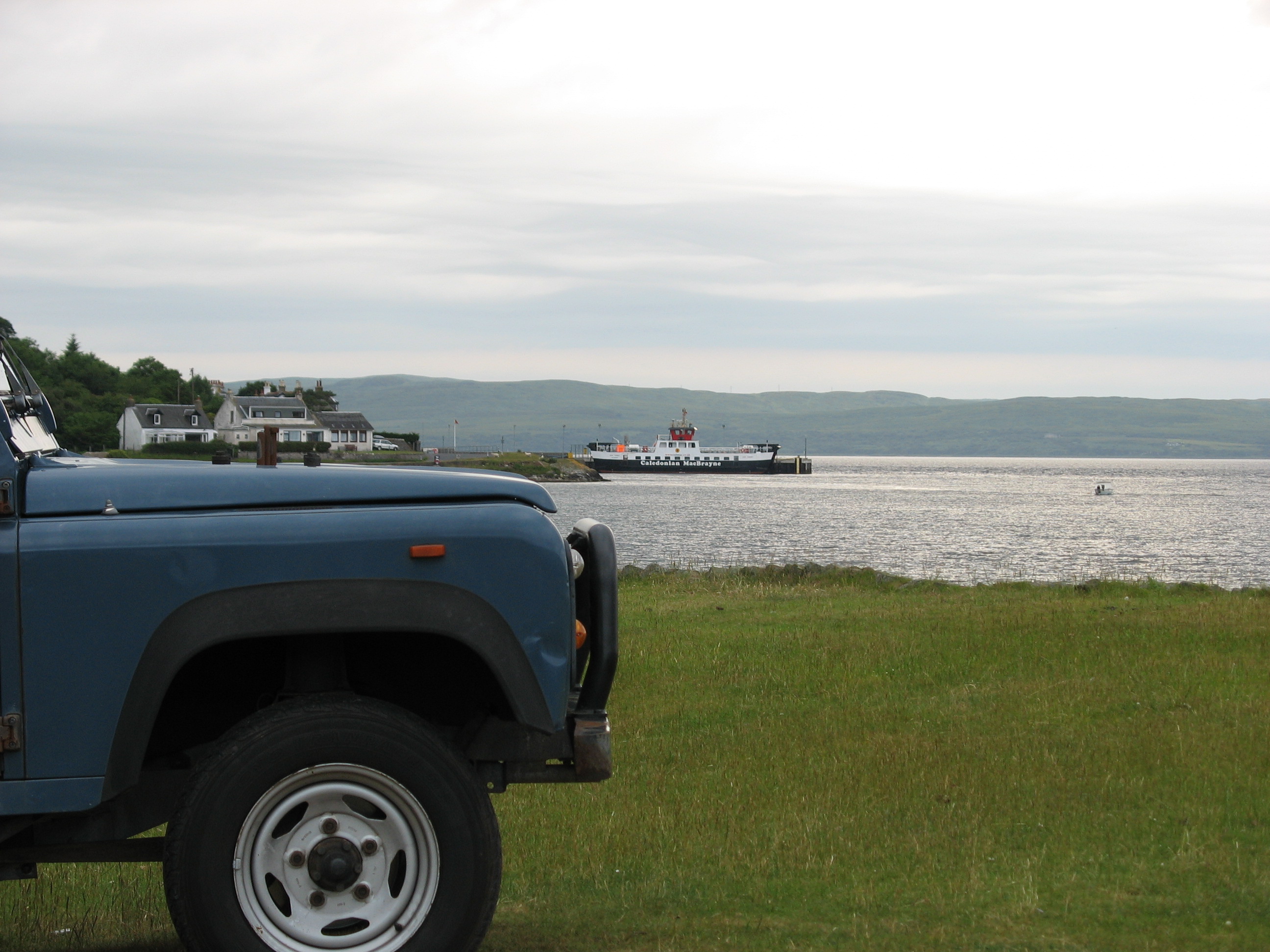 Land Rover parked on grass with sea view