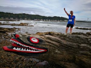 Girl in running clothes standing on the crocodile rock