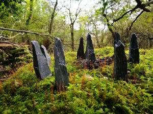 Mini standing stones sitting on a bed of green moss