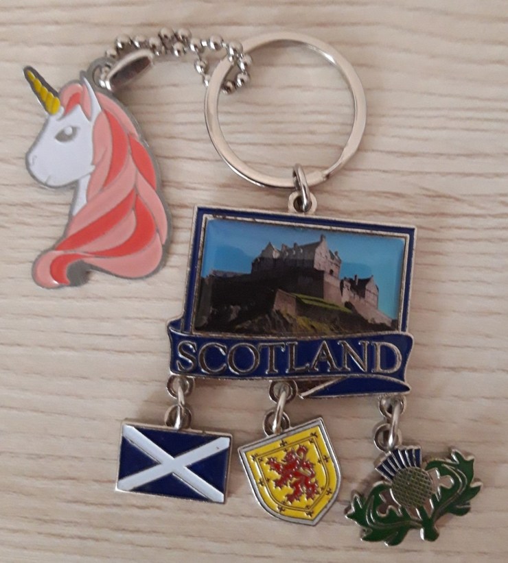 Unicorn head key ring (which is a geocache trackable) attached to a Scotland key ring including Edinburgh Castle, Scotland flag, Lion Rampant and a thistle