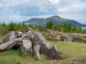 Old chambered tombs on a hill with a view to the Holy Island