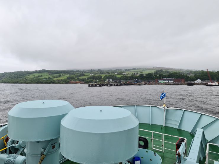 Ferry sailing, Scotland flag flying and land ahead