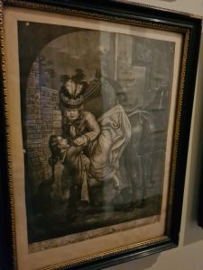 Gentleman struggling to help a lady off her horse