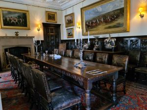 Large wooden table with chairs in a dining room
