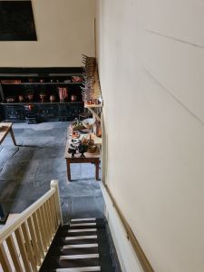 Narrow stairs leading down to a kitchen area