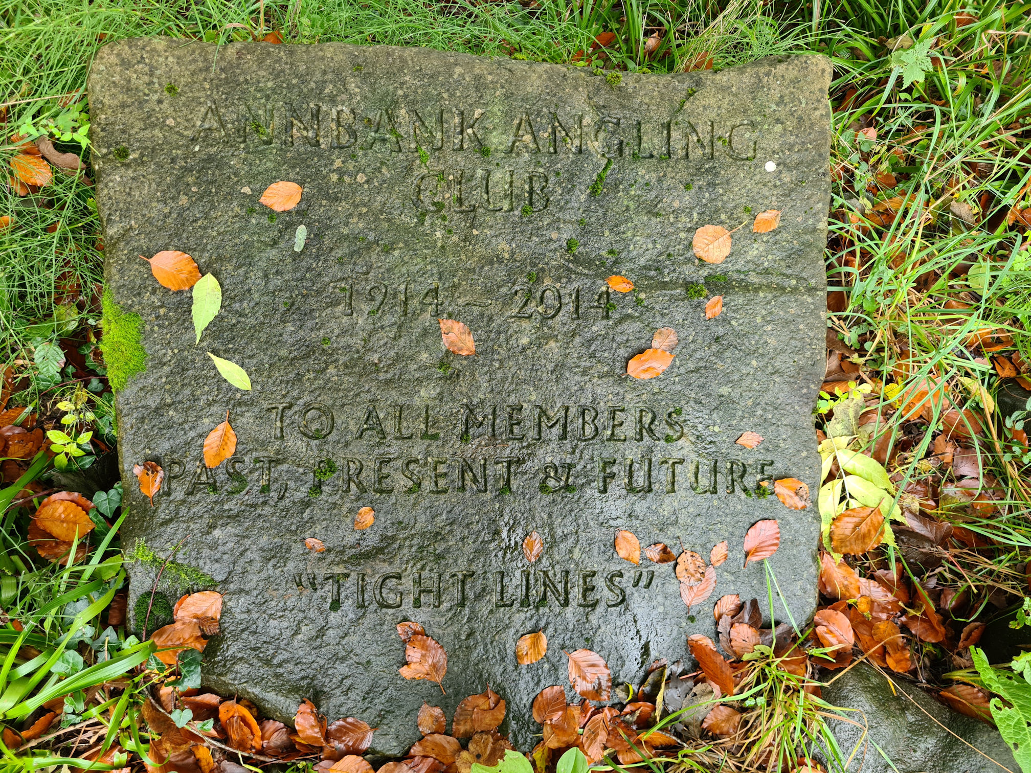 Stone slab inscribed with a dedication to the Annbank Angling Club from 1914 to 2014, to all members past, present and future.