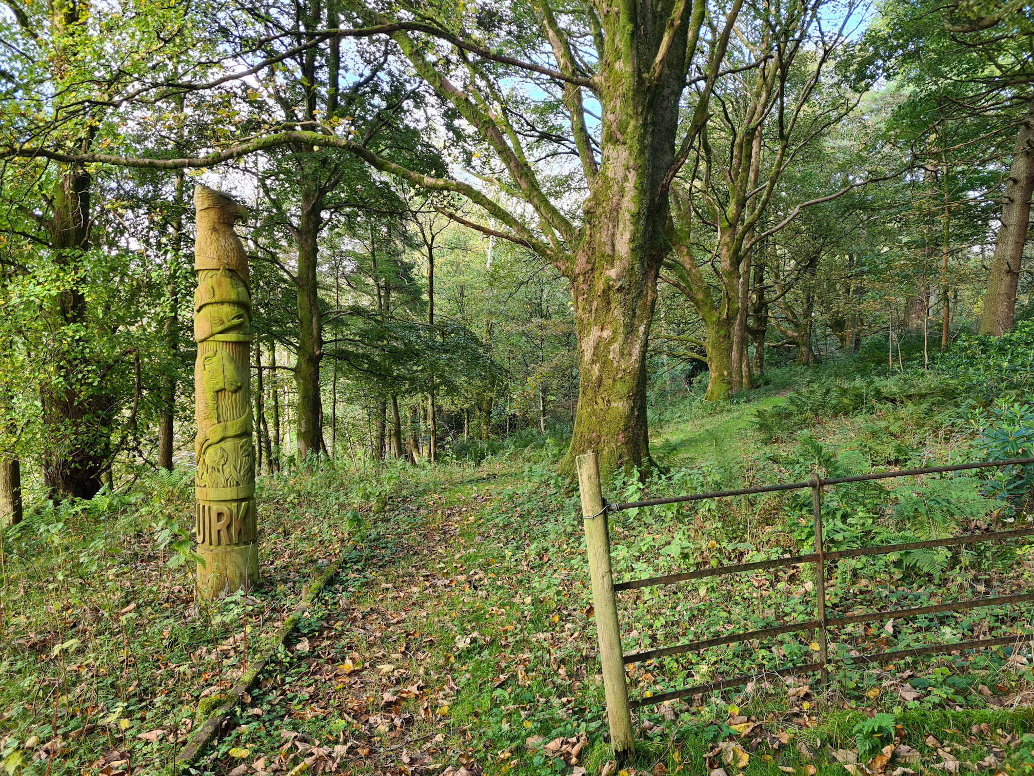 A wooden Totem Pole that tells a story of the village of Muirkirk, past and present