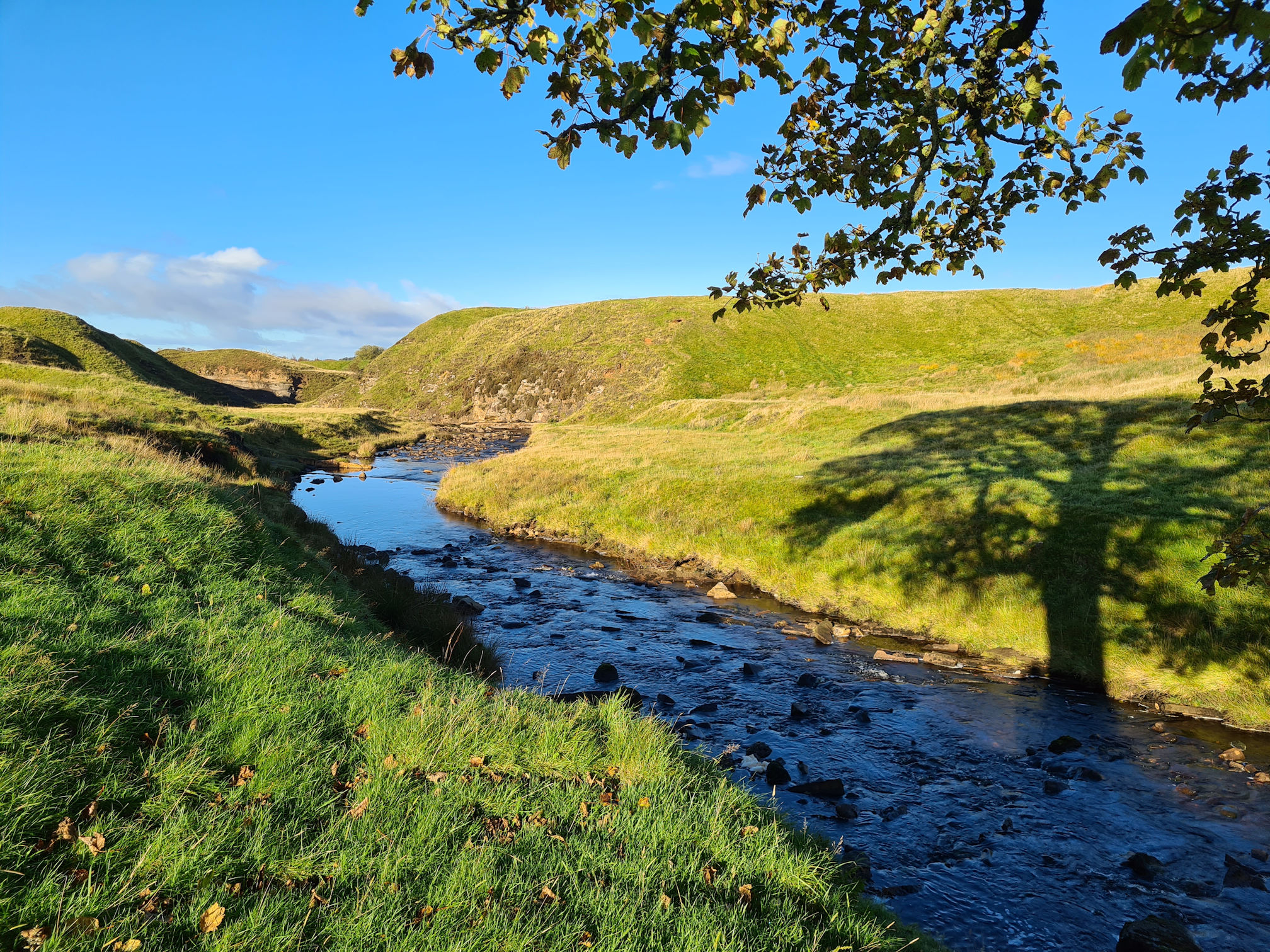 The Garpel Water, the a shadow of a tree is cast on the banks of the water