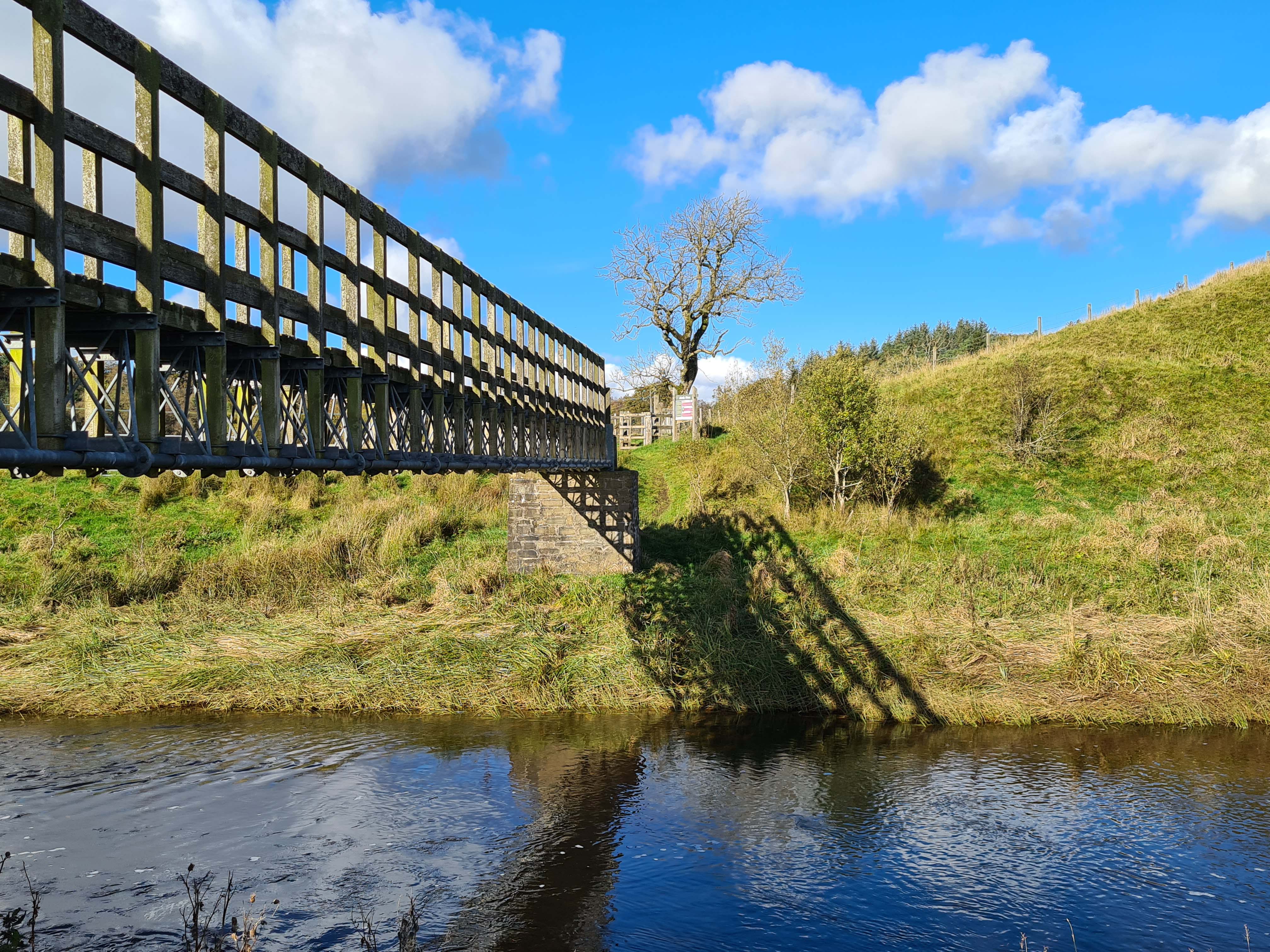 A high wooden bridge across the water at Airds Moss.