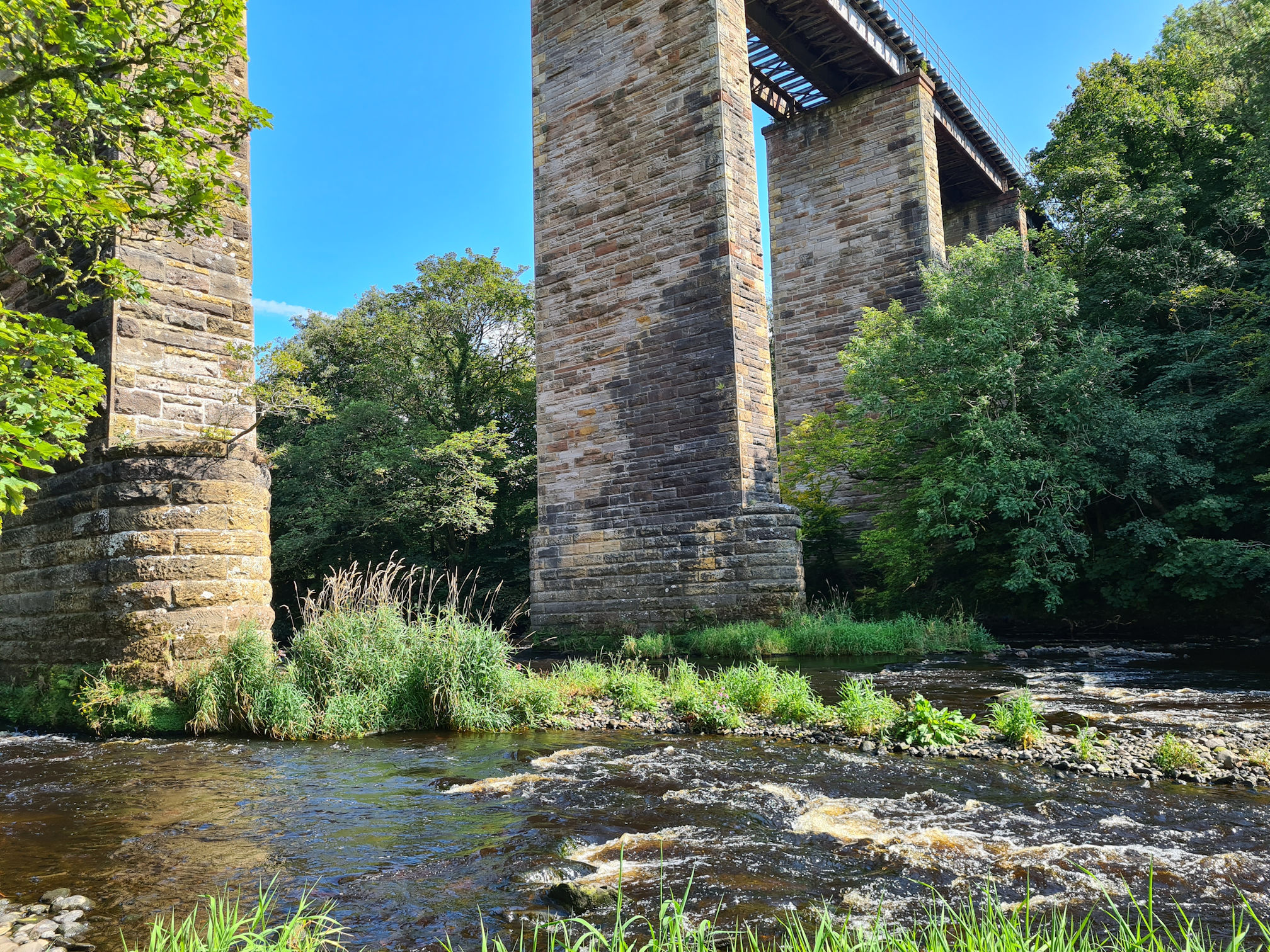 Tall railway bridge across the river