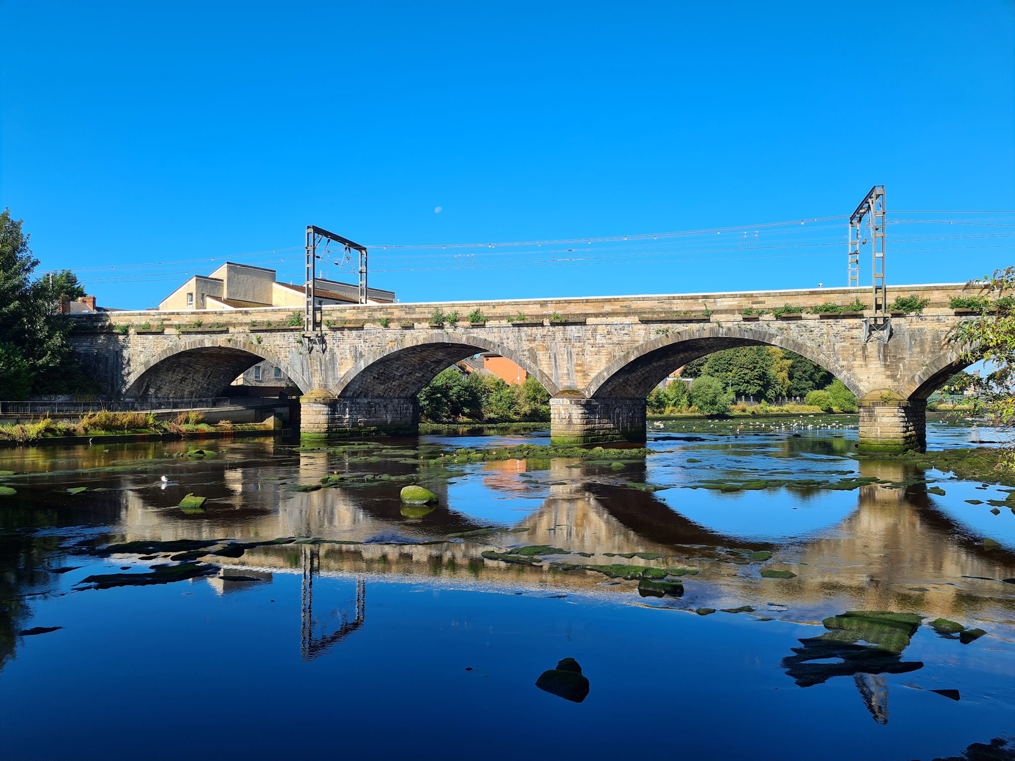 Railway Bridge across the River Ayr showing its reflection in the water