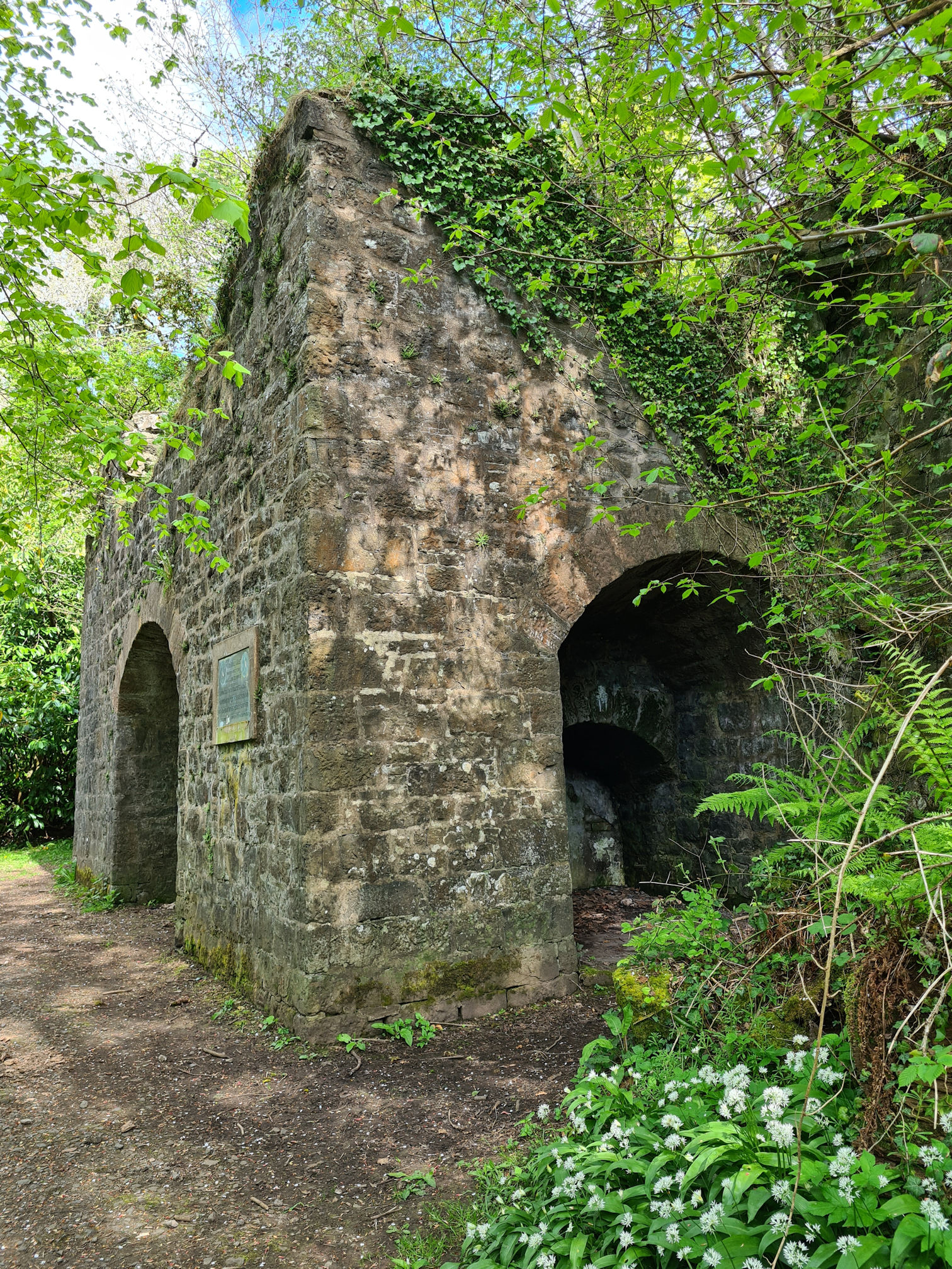 An old brick structure with arches visible on three sides, an 18th Century Limekiln