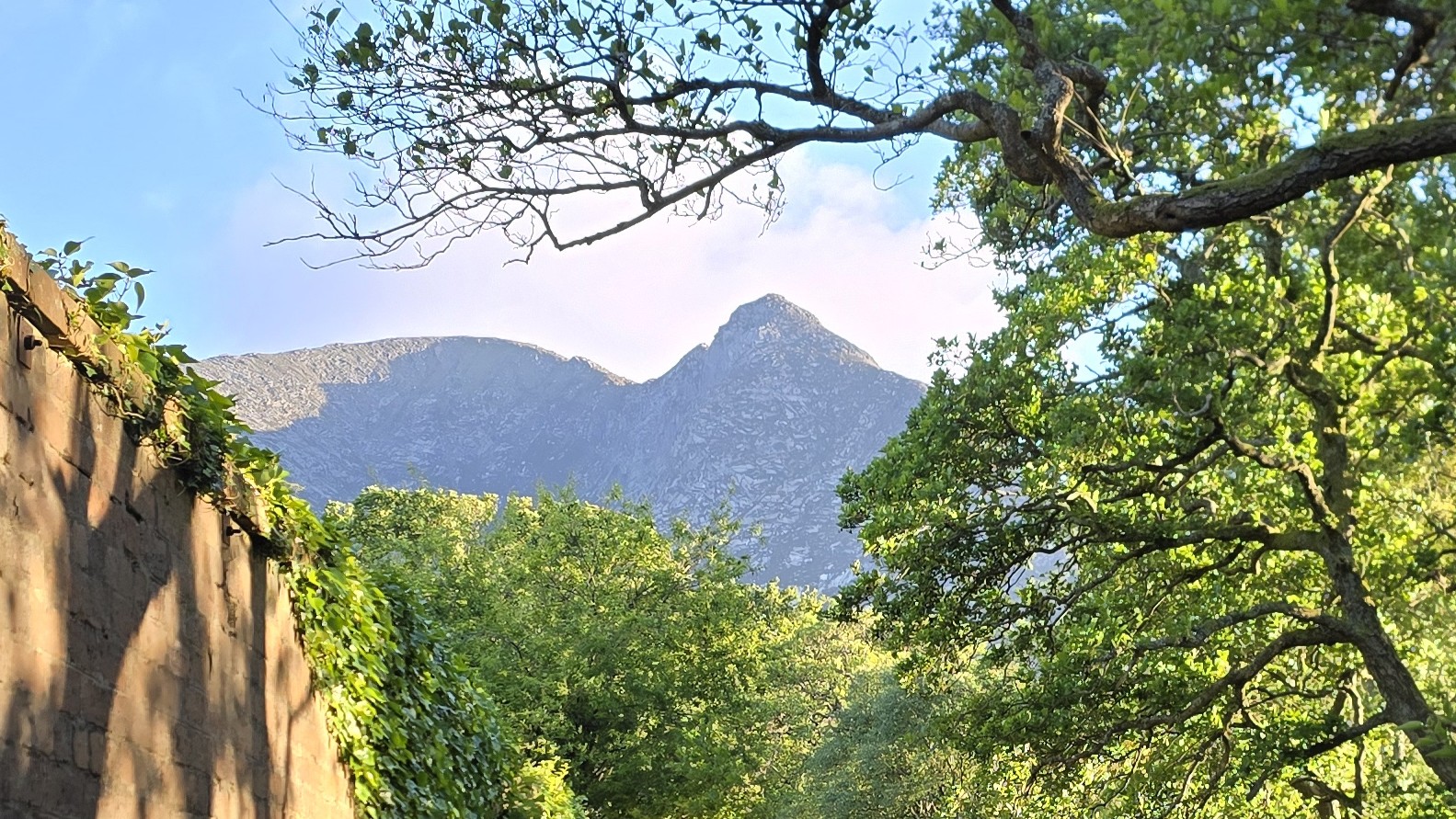 A shadow on a mountain that looks like a face profile face of the devil