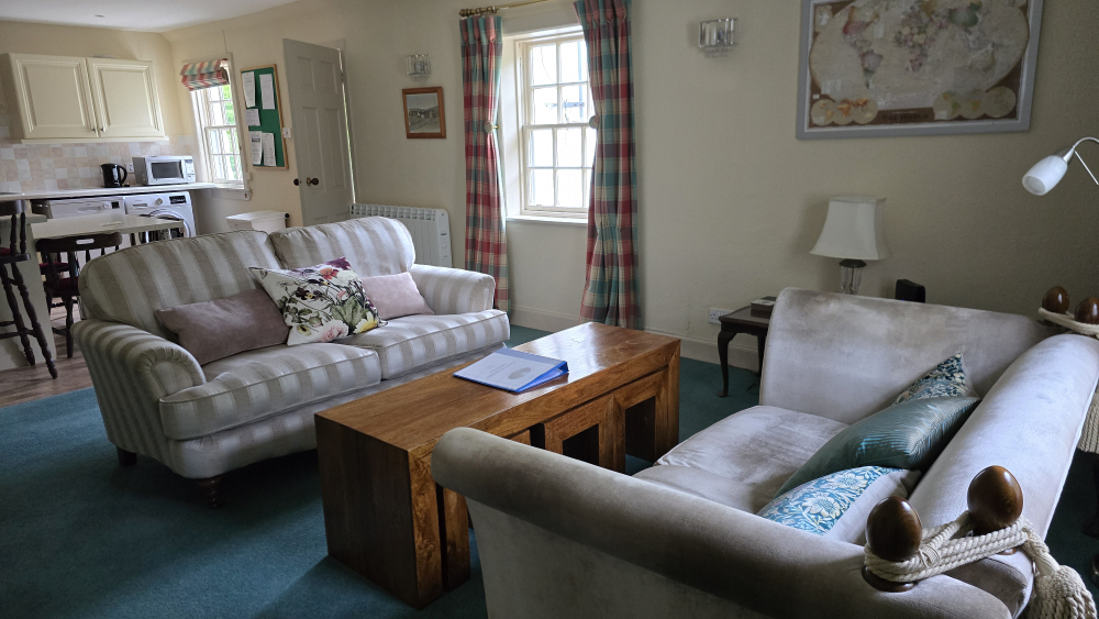 Living room area of the cottage, open kitchen at the far side