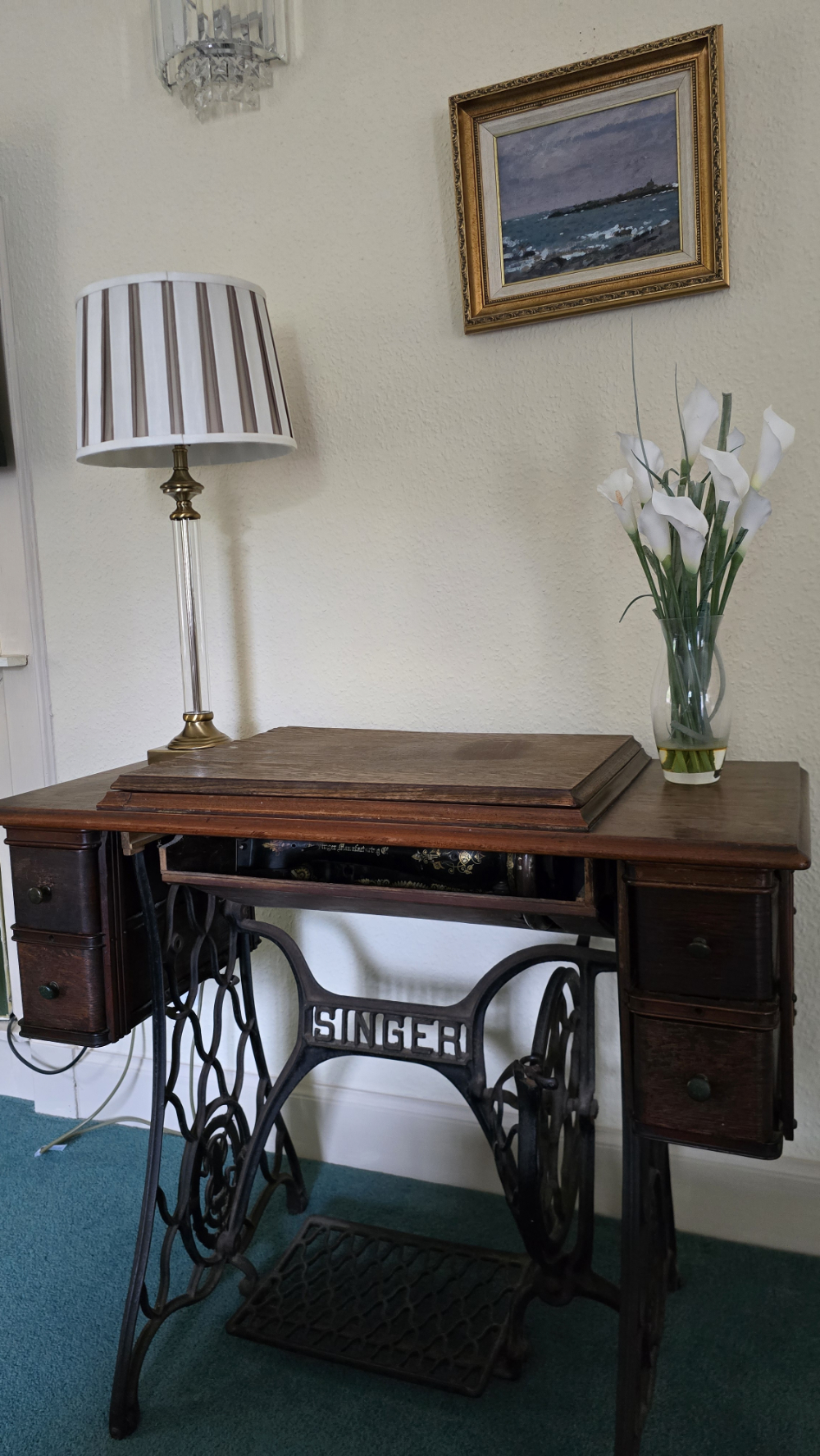 A beautiful old Singer sewing machine within a mahogany table