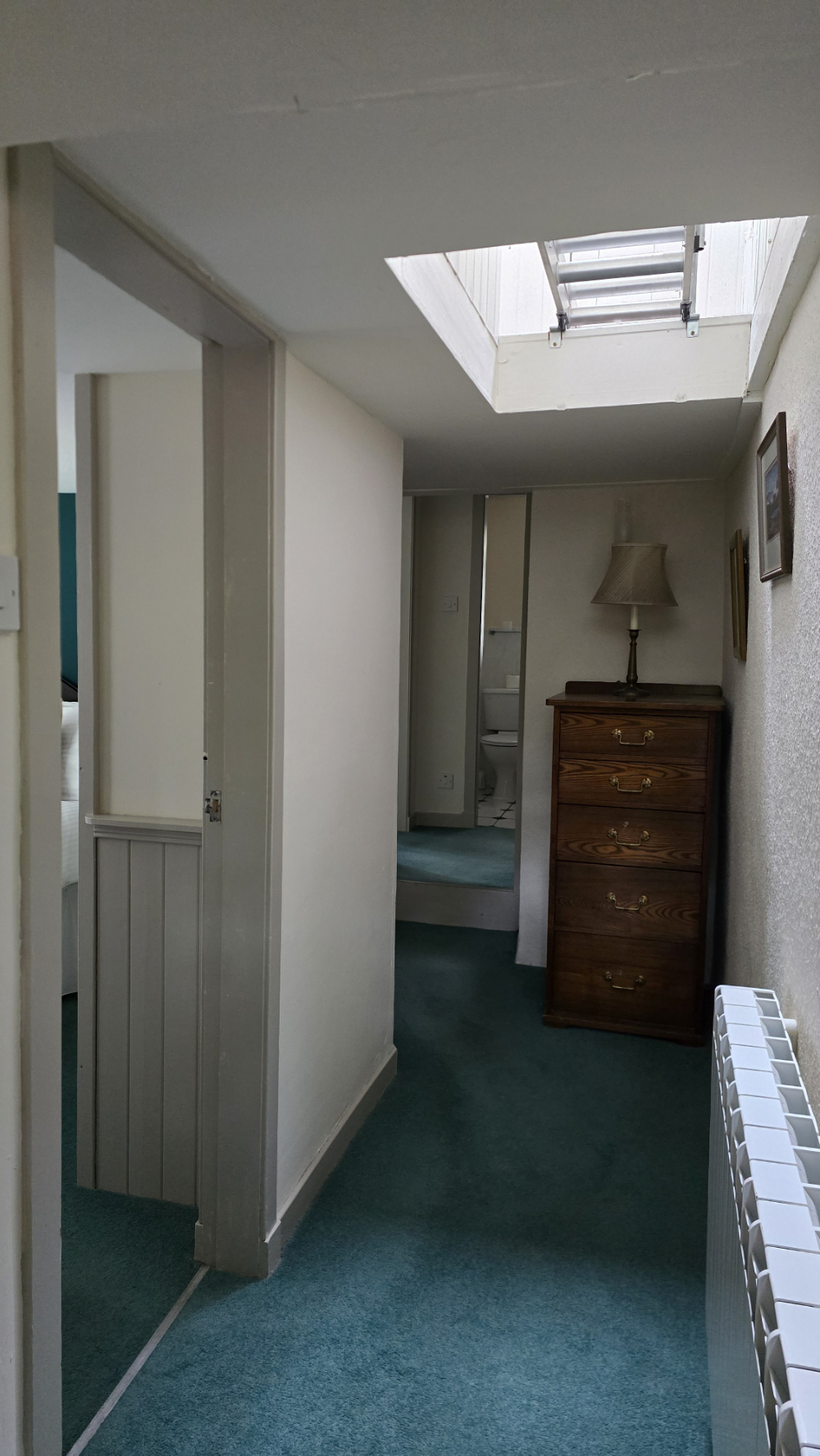 Hallway with access to bedrooms, bathrooms, attic and back door