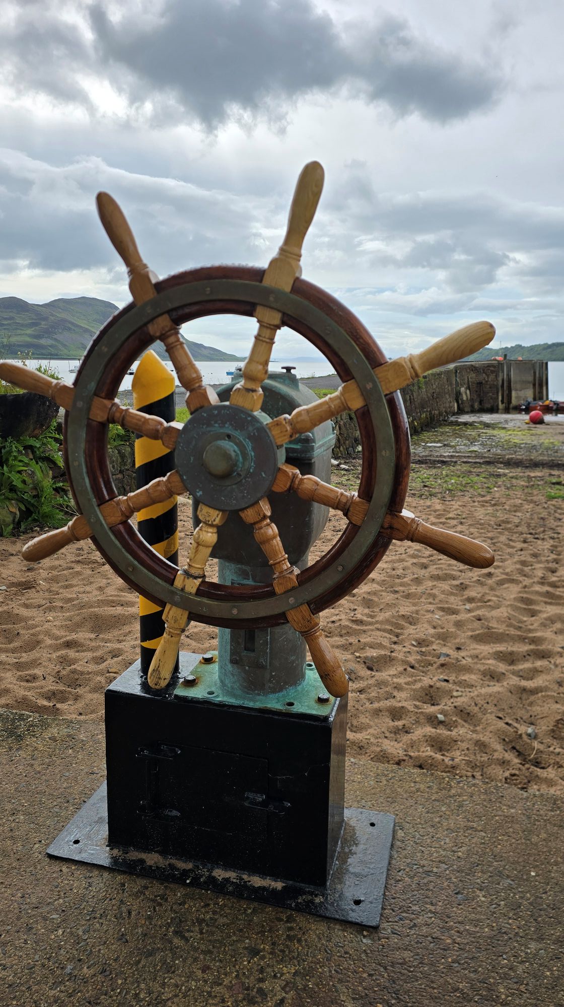 A steering wheel of a boat placed beside the pier. You can turn this and pretend you are sailing a boat.