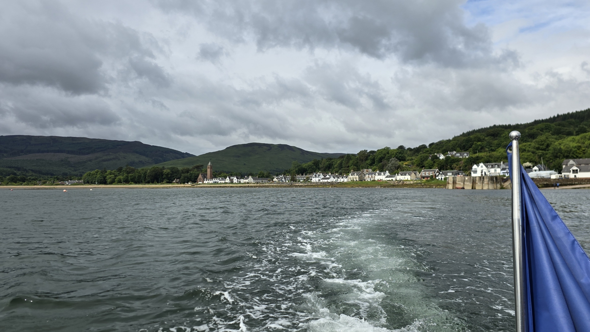 Water trail and view from a boat looking back at Lamlash on the Isle of Arran