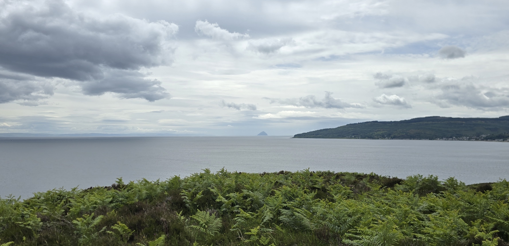 An open view across the sea from Holy Isle with Ailsa Craig and part of Arran in the distance