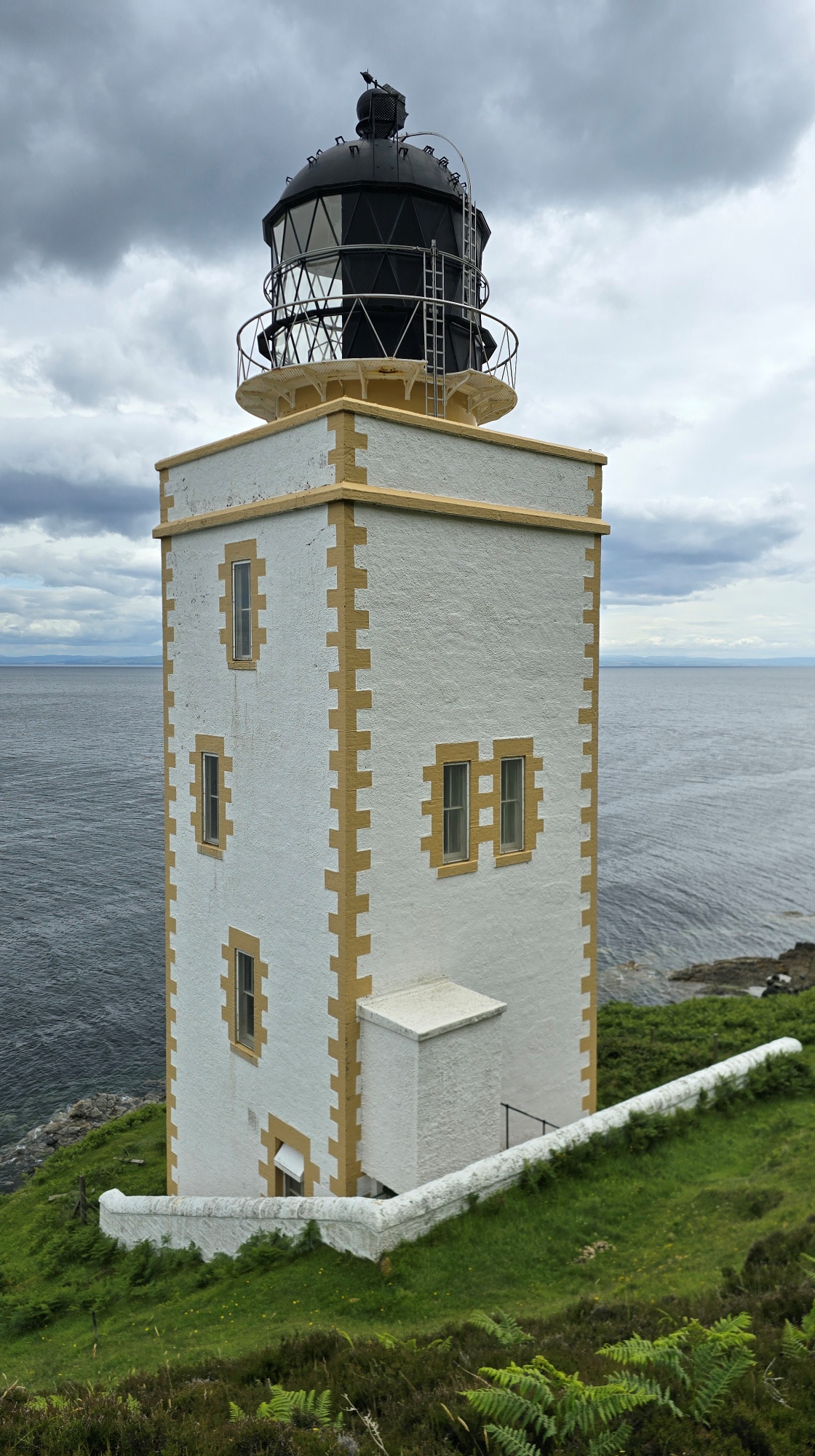 Pillar Rock Lighthouse, a square tower perched on the coastline of Holy Isle