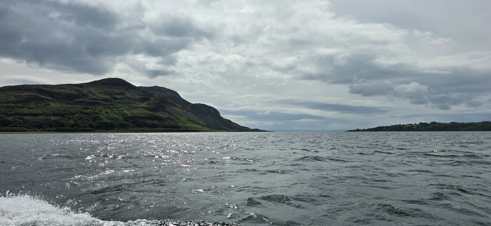 View from a boat, the sea and a glimpse of an island called Holy Isle