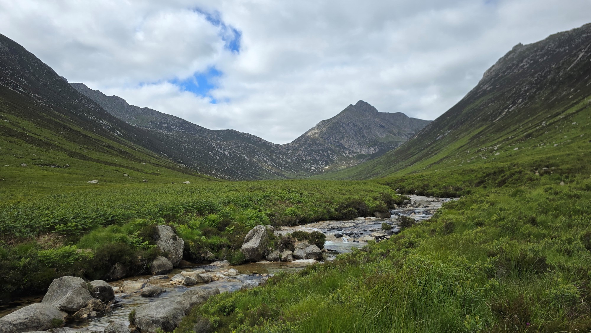 Water from the Sannox Burn and mountain peaks in the distance
