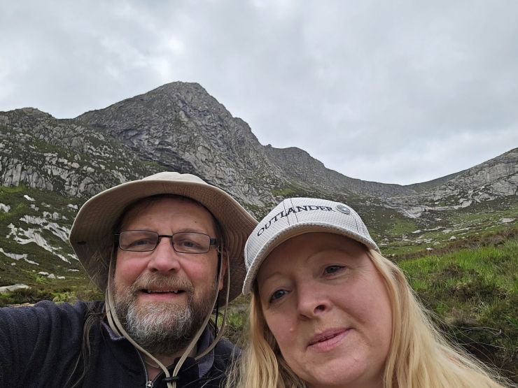 Middle-aged man and woman taking a selfie in the mountains