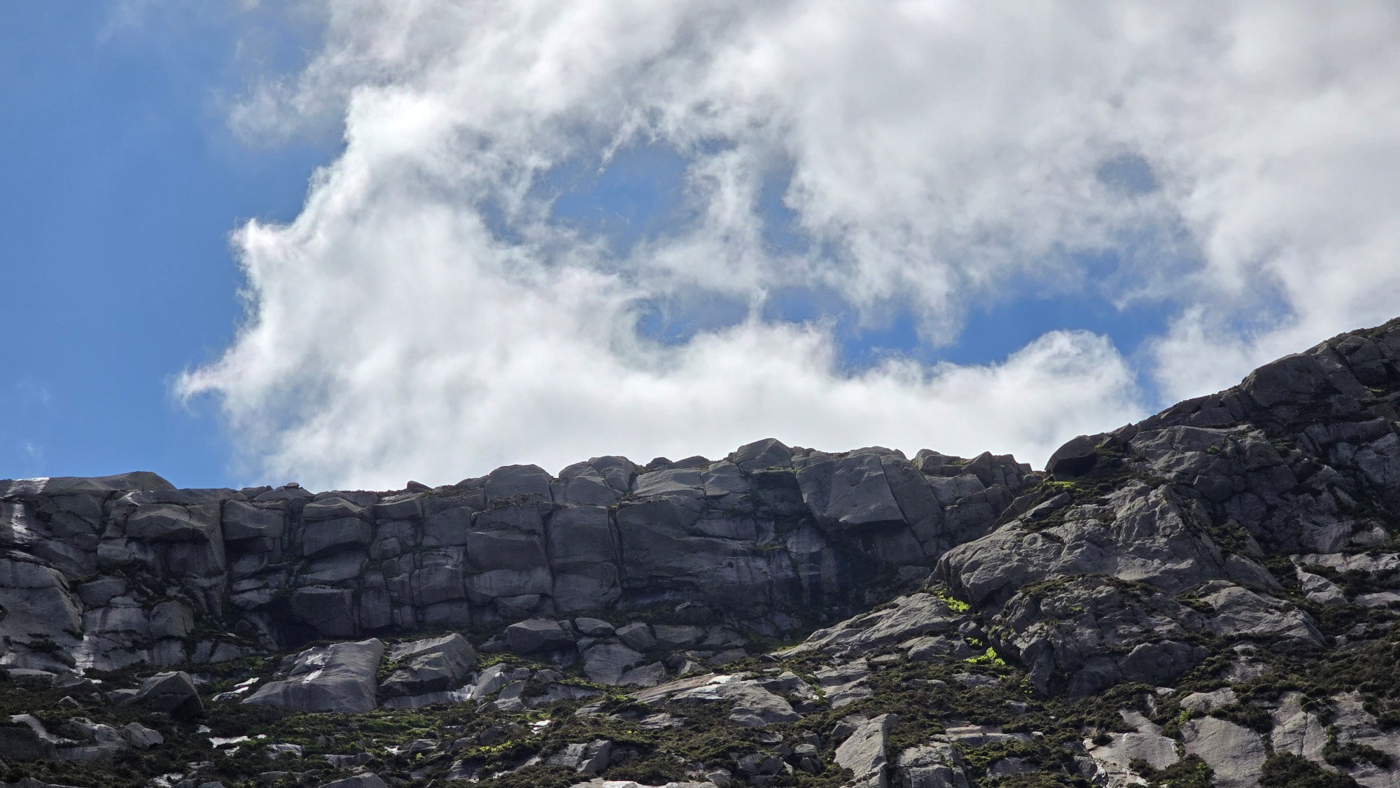 Rocky ridge of a mountain, looking up from below
