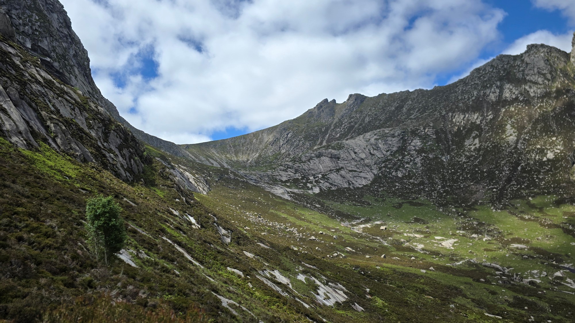 High view of mountains against a blue sky and white puffy fluffy clouds