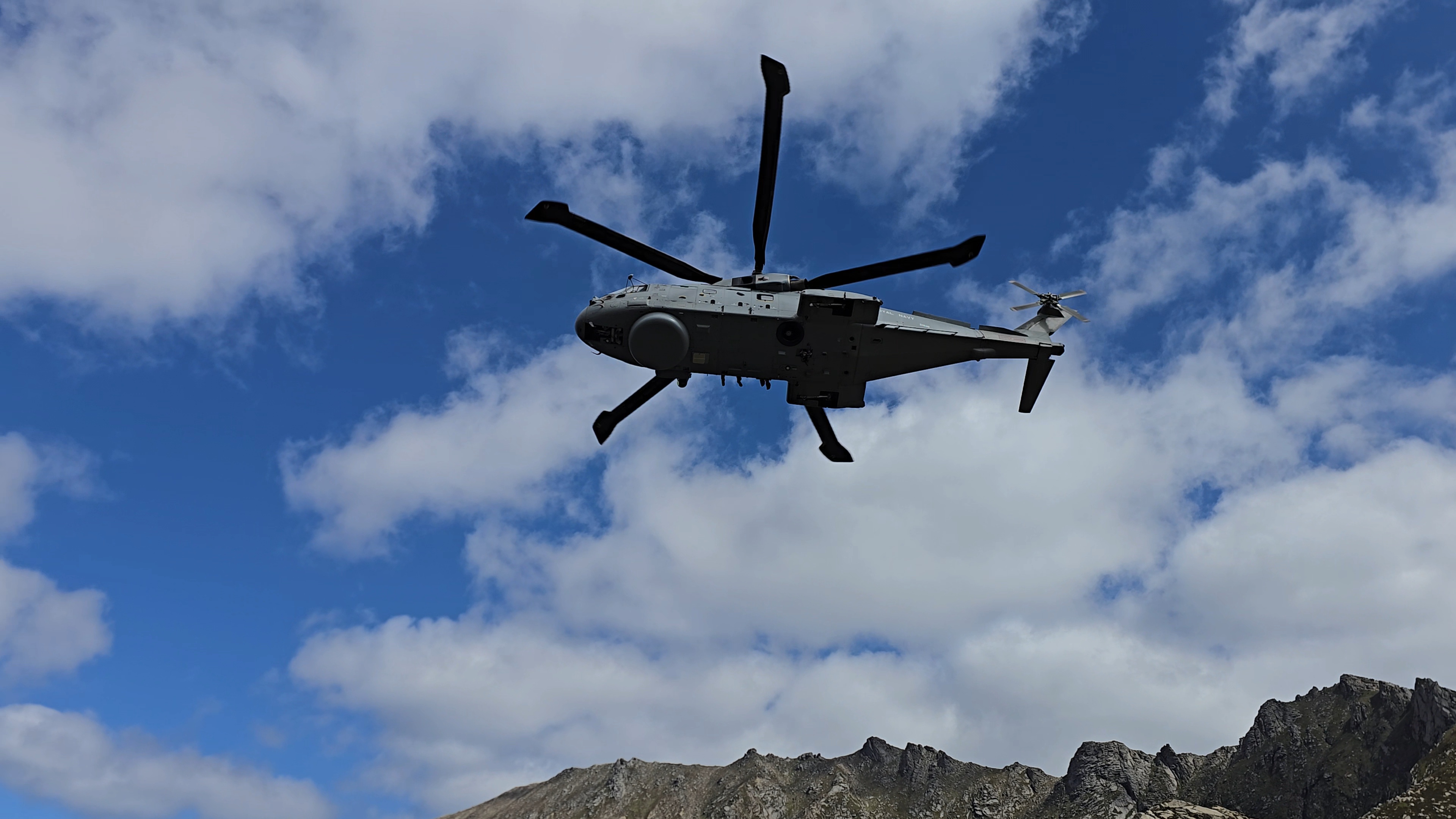 Royal Navy Helicopter flying through the mountains