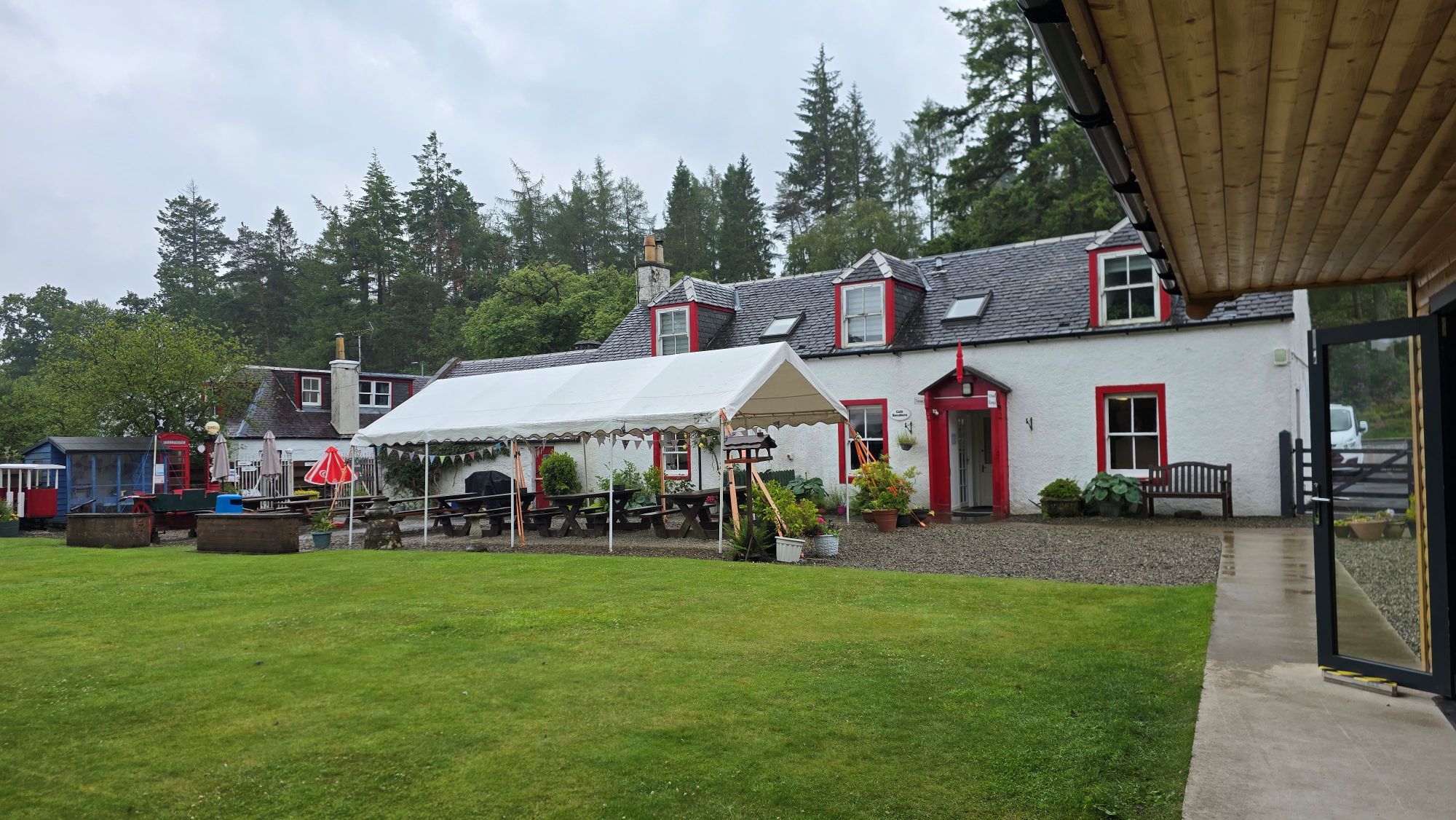 Grassy area, white building and outside seating