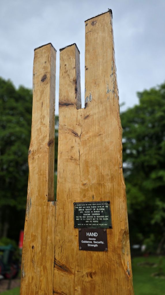 Shape of a hand as part of a wooden seat