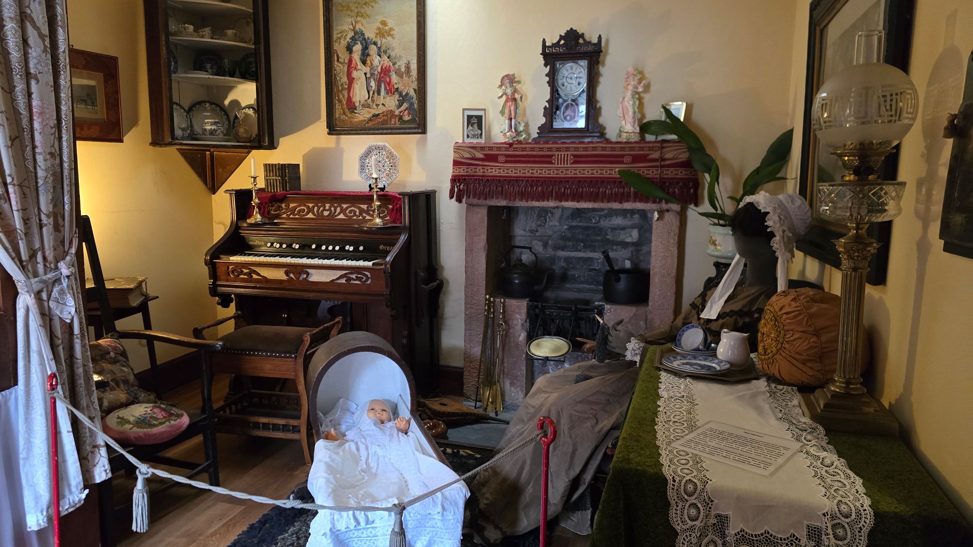Display of an old style sitting room with furniture, mother and baby