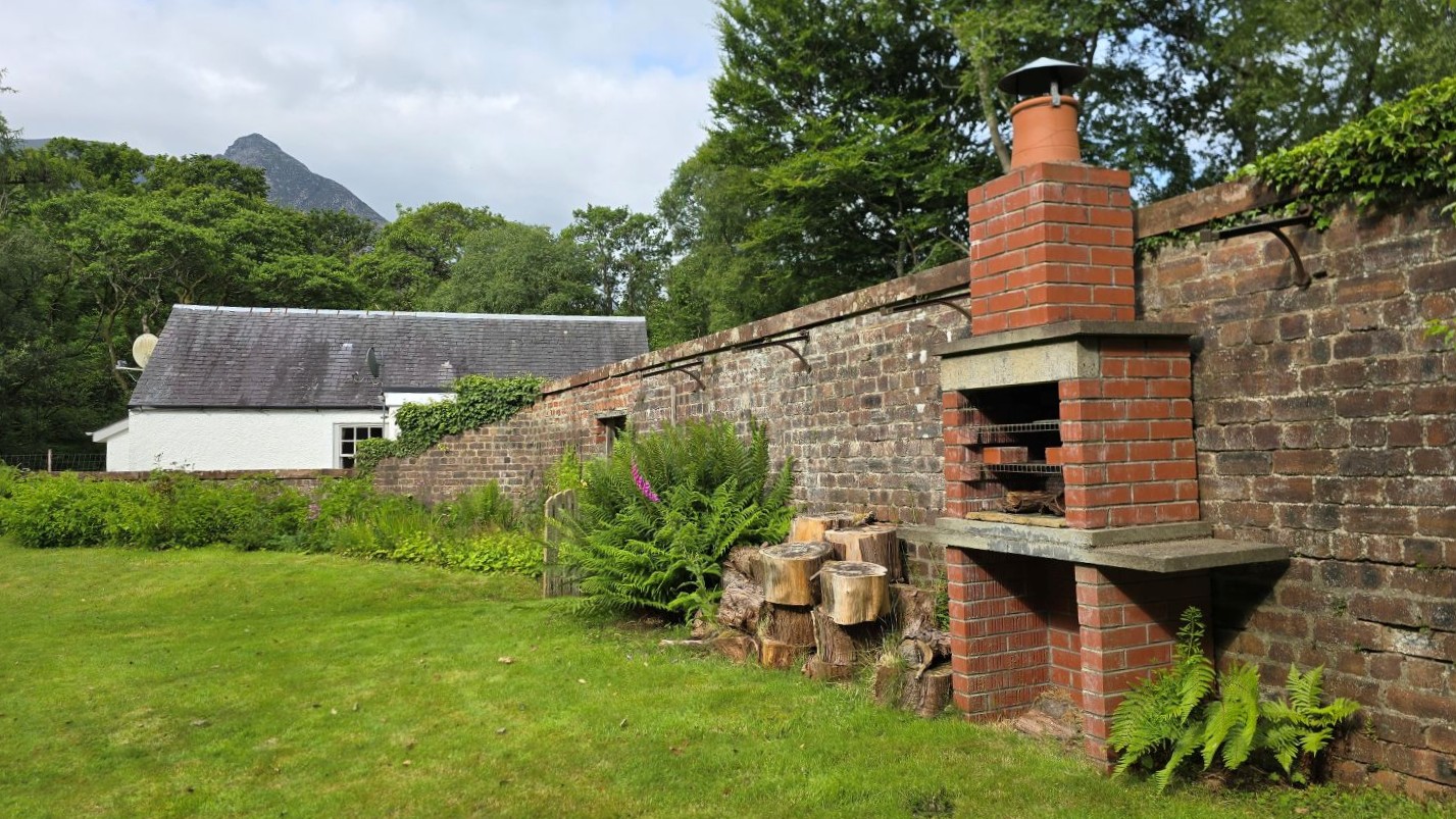 White cottage, walled garden and brick barbeque