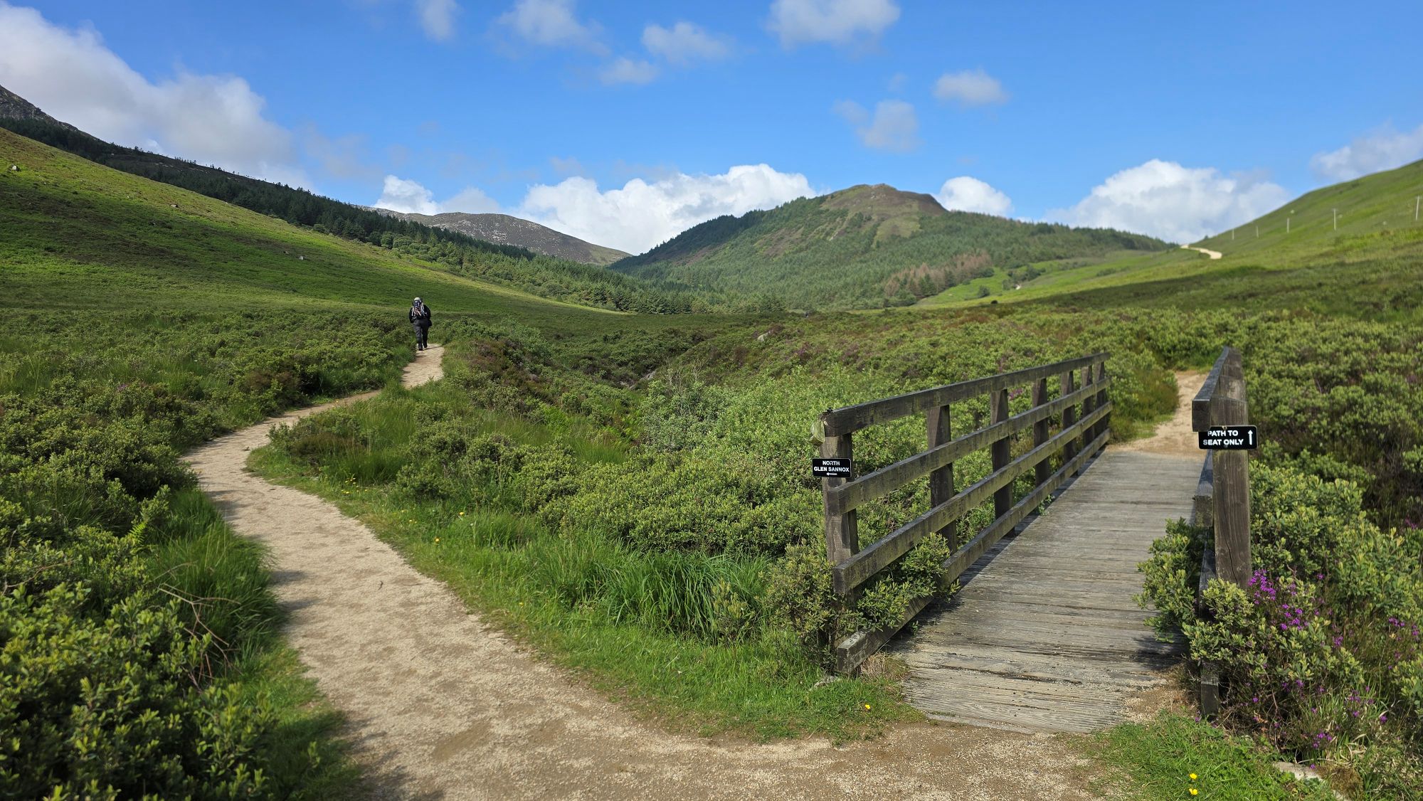 The choice of two paths. One takes you over a bridge to a seat, the other takes you further up the glen to the mountains