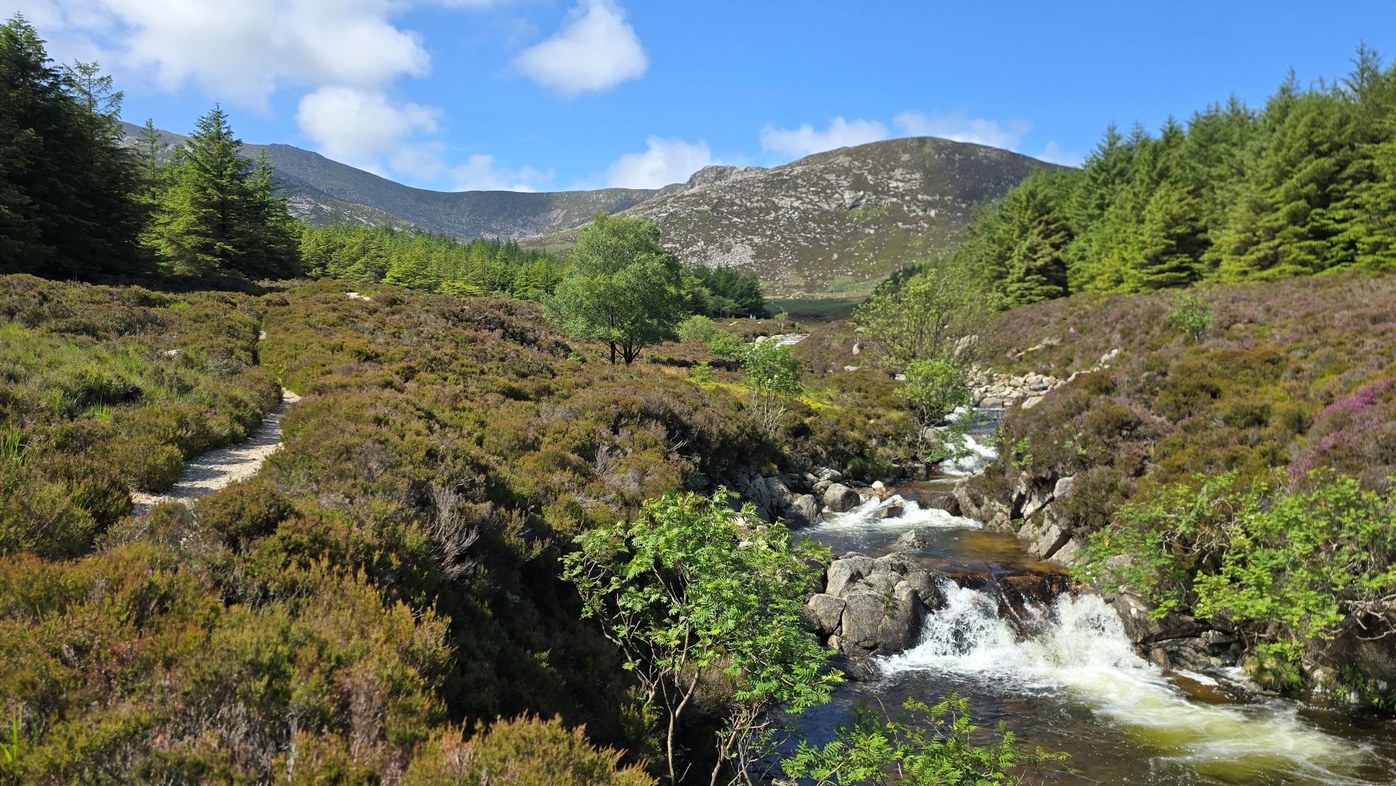 Waterfalls and path leading into the mountains