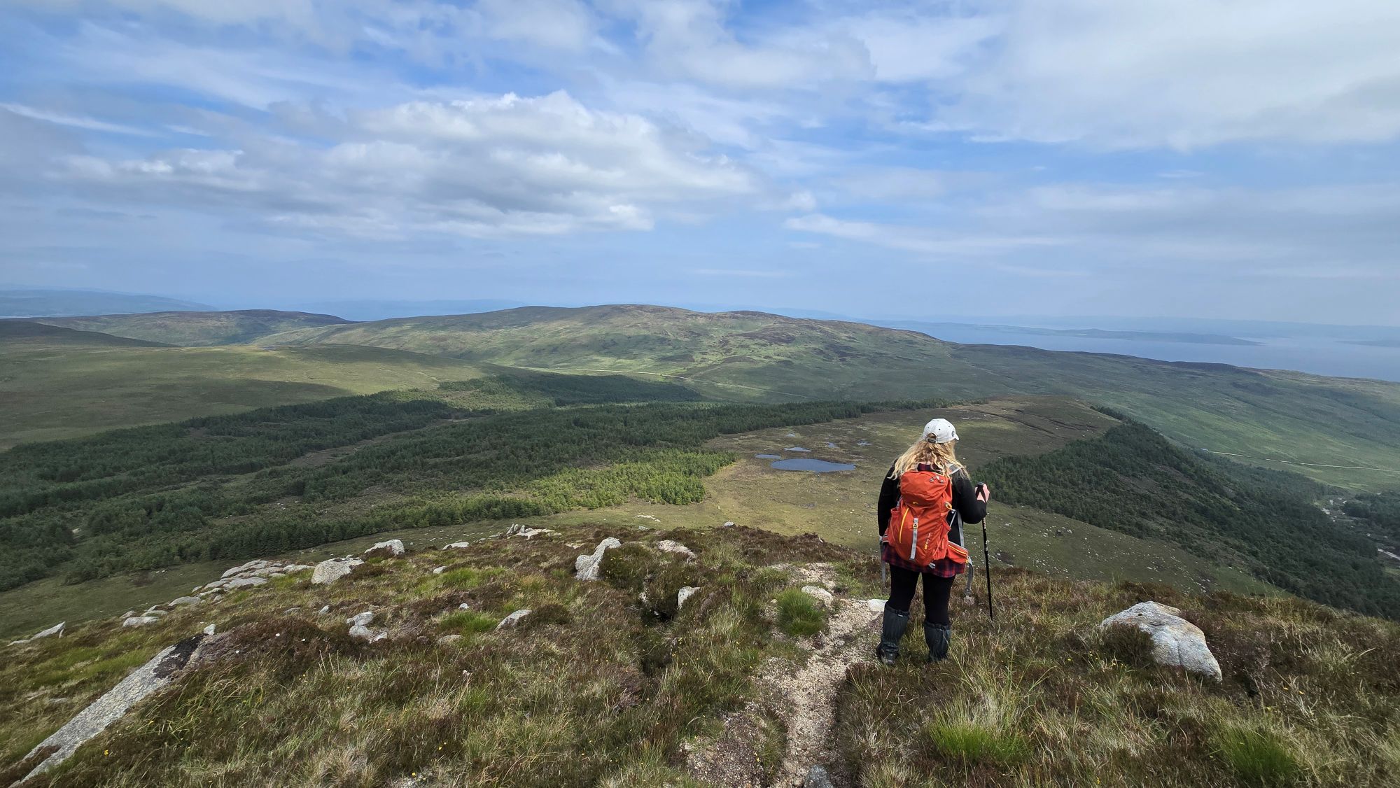 Girl standing on top of a mountain