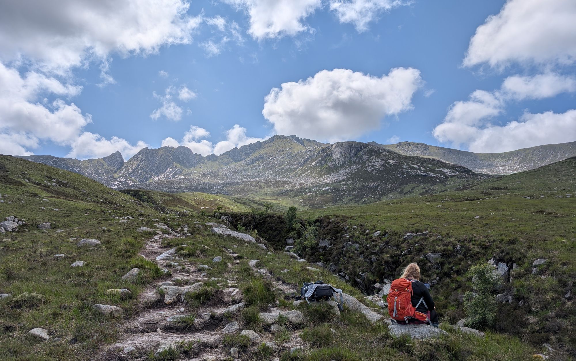 Girl sitting near a gorge in the mountains