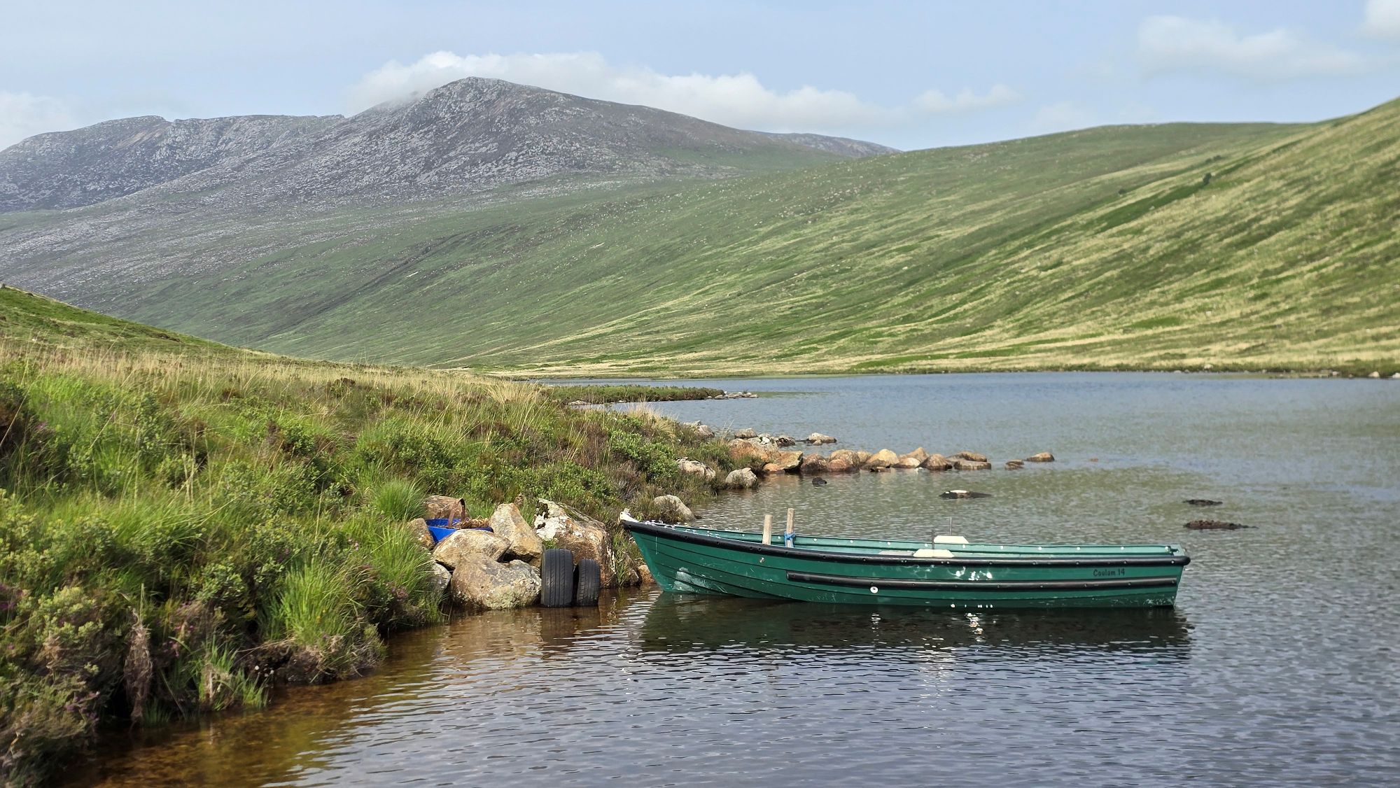 Little green boat sitting on Loch Iorsa